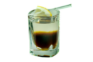 caffeine cocktail in shot glass with yellow lemon slice isolated on white