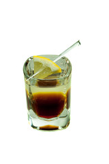 shot glass with caffeine cocktail and lemon slice isolated on white