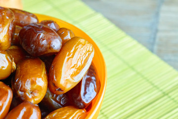 sweet algerian arabic dates fruits on an orange plate