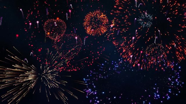 Massive fireworks display against a clear starry night sky.