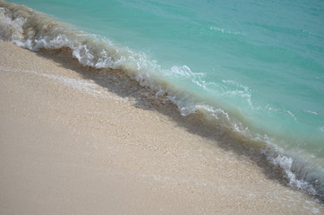 wave crashing alon the shore on the island of barbuda