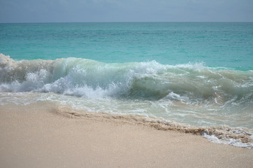 wave crashing along the shore on the island of barbuda