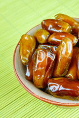 Sweet arabic algerian dates fruits on a ceramic plate