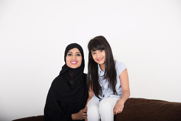 Arabic mother with her daughter at home