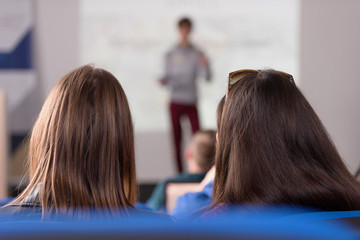 Businesspeople during business conference in conference room or hall.