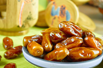 Sweet arabic algerian dates fruits on a ceramic plate