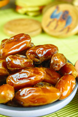 Sweet arabic algerian dates fruits on a ceramic plate