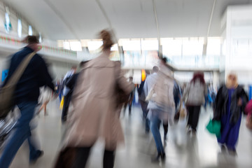 Blurred airport, traveler silhouettes in motion blur