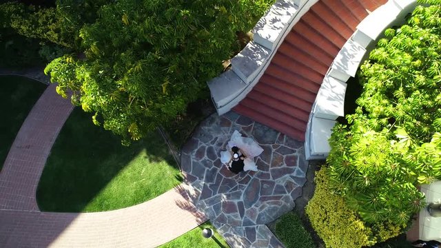 Aerial drone view of a brida walking down stairs on her wedding day