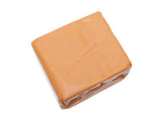 Brown cheese isolated on white background. Popular cheese in Scandinavia. Most iconic foodstuffs in Norway.