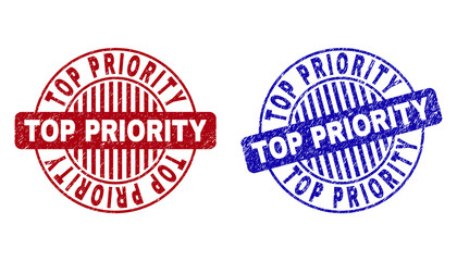 Grunge TOP PRIORITY round stamp seals isolated on a white background. Round seals with distress texture in red and blue colors.