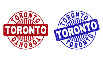 Grunge TORONTO round stamp seals isolated on a white background. Round seals with grunge texture in red and blue colors. Vector rubber overlay of TORONTO title inside circle form with stripes.