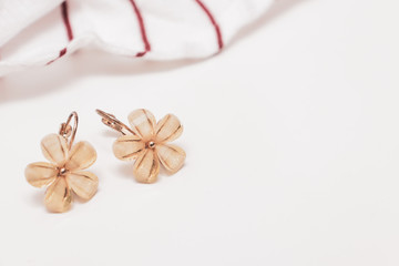 A pair of cristal flower form bijouterie earrings on white background with copy space