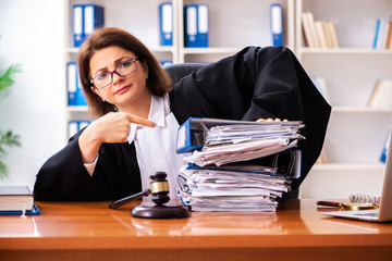 Middle-aged female doctor working in courthouse 