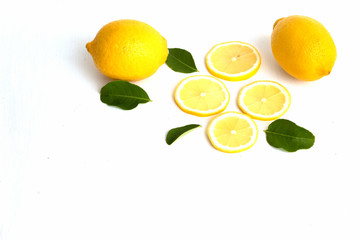 lemon with lime and leaves on white background