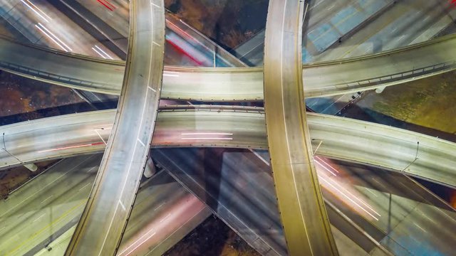 Cinematic urban aerial drone time lapse of interstate with traffic showing fast paced futuristic city lifestyle