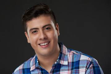 Headshot of happy hispanic young man