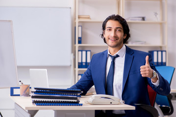Young handsome businessman working in the office