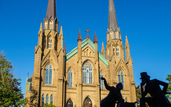 St. Dunstan's Basilica Cathedral, National Historic Site of Canada, and the bronze statue of two Fathers of Confederation in the beautiful morning in Charlottetown, Prince Edward Island