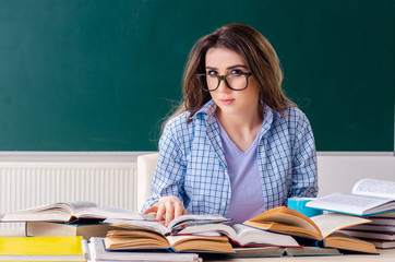 Female student in front of chalkboard 