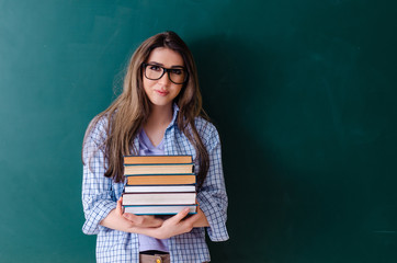 Female student in front of chalkboard 