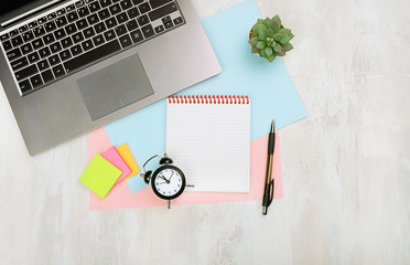 Top view of modern office desk table with computer laptop and pen, empty note, clock alarm, succulent. modern workspace, office or freelance. Deadline concept. flat lay, copy space