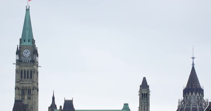 Parliament of Canada Peace Tower against overcast sky - tilt down - March 15th 2019 Ottawa Ontario Canada
