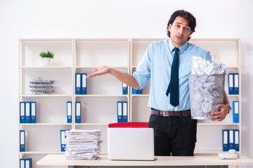 Businessman rejecting new ideas with lots of papers