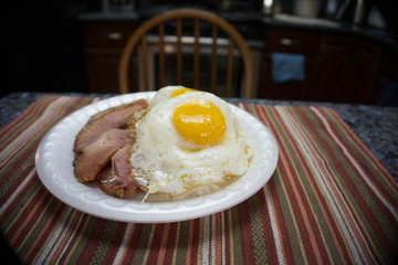 Rice and ham topped with two eggs plate lunch in an empty kitchen on the table