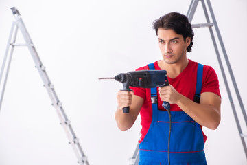 Young handsome contractor working indoors 
