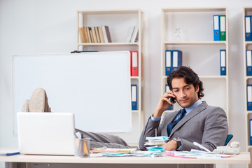 Young handsome businessman in budget planning concept 