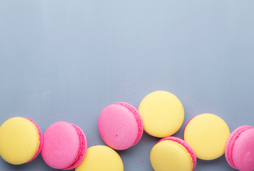 Fototapeta na wymiar Pink yellow macaroons cake on gay background, neon color, place for text, creative layout, top view