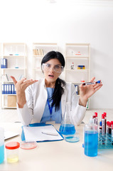 Female chemist working at the lab  