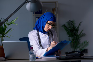 Arab female doctor working in the clinic at night 