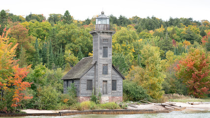 old wooden lighthouse in autumn