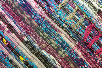 Needlework. Textile fabric background with diagonal lines. A rug for home made from colorful...