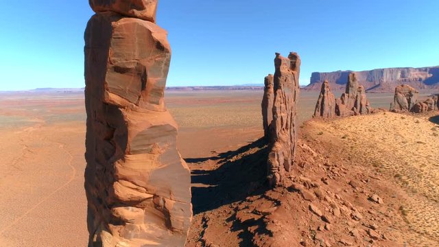 MONUMENT VALLEY, ARIZONA, USA. Desert terrain straddling the border of northeastern Arizona and southeastern Utah of the Colorado Plateau - aerial 4K view.