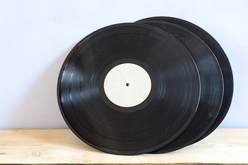 Old vinyl records on a wooden table.