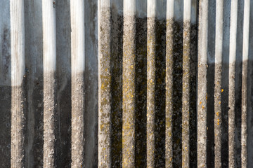 The texture of an old asbestos house roof in a village or an old