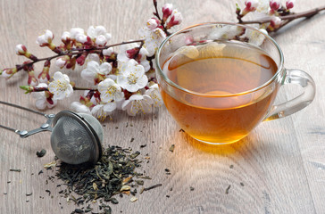 cup of tea and spring flowers on a wooden table