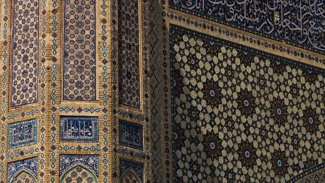 Handheld, panning, exterior, medium close up shot of the Bibi Khanym Mosque in Samarkand, Uzbekistan.