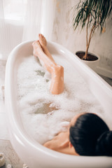 Fototapeta premium Beautiful sexy woman in bubble bathtub