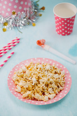 Fototapeta na wymiar Birthday party items with popcorn on table