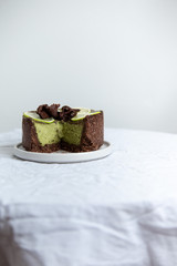 Vegan healthy No-bake avocado lime cheesecake on white background with copy space