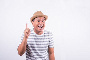 Young Asian man with hat feels shock and surprise with overly face expression.
