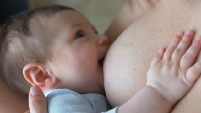 Breast feeding, breastfeeding concept. Happy Mother feeding her Newborn baby.