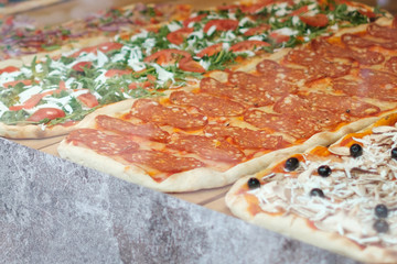 pizza for sale, slice of pizza behind display window  -