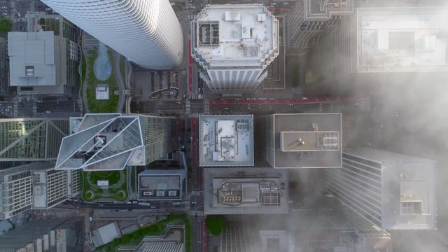 SAN FRANCISCO, CA, USA. Aerial view of skyscrapers with walls composed of clear glass with pearlescent metal accents. Tower tops within busy streets of San Francisco downtown.