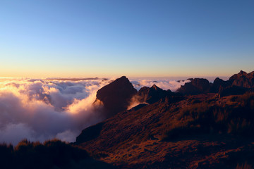 Sunset in the clouds at the height of the Pico do Arieiro on the island of Madeira. Portugal. Background, outdoors, nobody, horizontal. Concept of natural beauty.