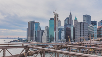 Buildings and skyscrapers of downtown Manhattan from Brooklyn Bridge, in New York, USA